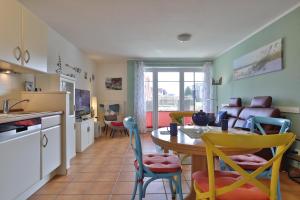 a kitchen and dining room with a table and chairs at 2 Zimmer Appartement Poseidon in Boltenhagen