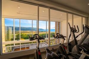 a gym with two exercise bikes in front of a window at Luxury Condo with Stunning View and Pool in Baie-Saint-Paul