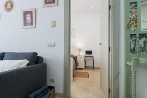 a living room with a couch and a desk at LuxSevilla Apartment Piscina in Bormujos +14 photos