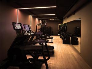 a dark room with a row of chairs in a gym at Met Hotel Amsterdam in Amsterdam