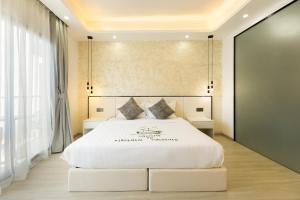 a bedroom with a large white bed with two pillows at Kirulhiya Omadhoo - Live the Island Dream in Omadhoo