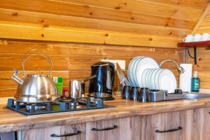 a kitchen counter with a tea kettle and plates at Veranda Buknari in Buknari