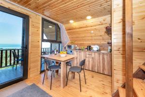 a kitchen with a table and chairs in a cabin at Veranda Buknari in Buknari