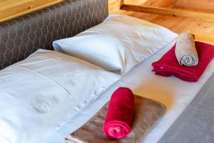 a bed with two pillows and two towels on it at Veranda Buknari in Buknari