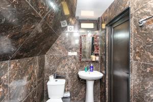 a bathroom with a toilet and a sink at Veranda Buknari in Buknari +21 photos