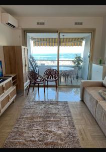 a living room with a couch and a table and chairs at Casa Monica Nizza VILLENEUVE-LOUBET in La Celle-sous-Gouzon