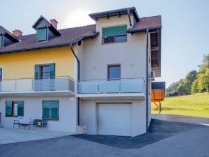 a large white house with a garage at Ferienwohnung 2 am Gleichenberger "Kogl" in Bad Gleichenberg