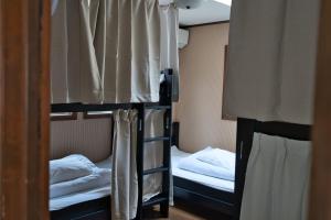 a room with two bunk beds and a window at IZA Kamakura Guest House and Bar in Kamakura