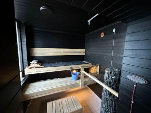 a sauna with a bench in the middle of a room at Kurimon Majatalo in Kianta