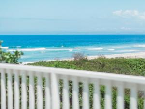 a view of the beach from a white fence at Sun and Sea Glentana in Glentana