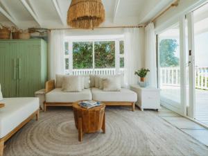 a living room with a couch and a table at Sun and Sea Glentana in Glentana +3 photos