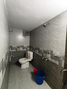 a bathroom with a toilet and a sink at Hotel Pink Orchid in Chittagong