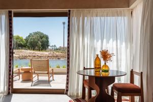 a living room with a table and a large window at Good Days Habitat Soma Bay in Hurghada