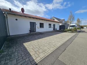 a white building with a red roof at Holidayhouse4You in Schwanau