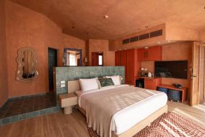 a bedroom with a large bed and a flat screen tv at Good Days Habitat Soma Bay in Hurghada +31 photos