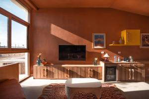 a living room with a tv and a couch at Good Days Habitat Soma Bay in Hurghada