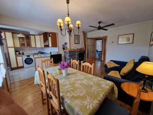 a dining room and living room with a table and chairs at VALDI-BIESCAS in Biescas +19 photos