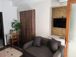 a living room with a couch and a flat screen tv at Two Lions Hotel in Tbilisi City +78 photos
