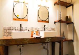 a bathroom with two sinks and two mirrors at Rivers Edge Lofts - Unit 4 in Niles +30 photos