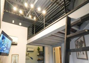 a room with a tv and a ceiling with beams at Rivers Edge Lofts - Unit 4 in Niles
