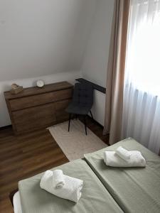 a room with two beds and a desk and a chair at KörösPartOn in Békésszentandrás +16 photos