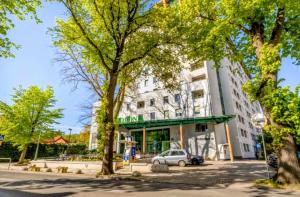 a building with a car parked in front of it at M-Apartamenty in Kołobrzeg