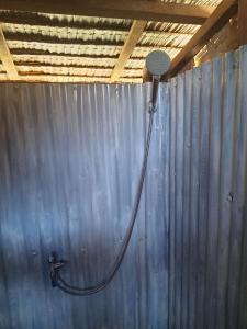 a shower with a hose hooked up to a wall at RENDER VOUS A'l MER in Puerto Princesa City