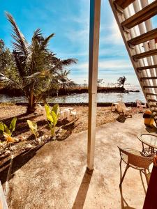 a view of a beach with a table and chairs at Tchin tchin Guesthouse in Ko Chang