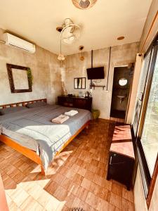 a bedroom with a bed and a flat screen tv at Tchin tchin Guesthouse in Ko Chang