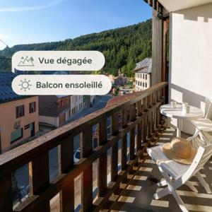 a balcony with a table and chairs on a building at L'HappyMijoux in Mijoux
