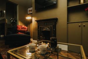 a living room with a coffee table and a fireplace at Spacious 2 Bed House Lancaster in Lancaster