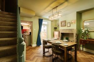 a dining room with a table and chairs and a staircase at Spacious 2 Bed House Lancaster in Lancaster