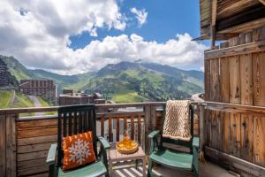 a balcony with chairs and a view of a mountain at Résidence Pierre & Vacances Electra in Avoriaz +31 photos
