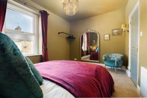 a bedroom with a bed and a window and a mirror at Spacious 2 Bed House Lancaster in Lancaster