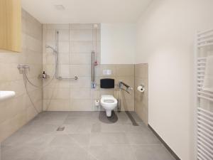 a bathroom with a toilet and a shower at smartments Frankfurt Airport in Frankfurt +38 photos
