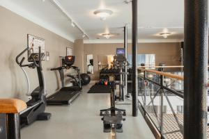 a gym with treadmills and machines in a room at Home Hotel Victoria in Jönköping