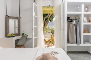 a bedroom with a bed and a desk and a window at Palatiana Agriturismo-Philoxenia Cottages Retreat in Galini +67 photos