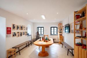 a dining room with a table and benches at Art house Tufi in Bistrica ob Sotli