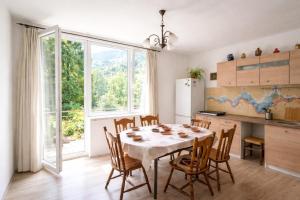 a kitchen and dining room with a table and chairs at Art house Tufi in Bistrica ob Sotli