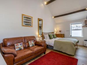 a living room with a couch and a bed at The Gables Studio in Keswick
