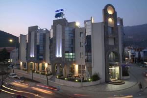 a large building with a street in front of it at Hotel Blue Star in Budva