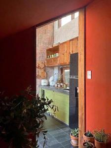 a kitchen with wooden cabinets and a green counter top at Sum Homestay Hue - Gần cầu Nguyễn Hoàng in Hue