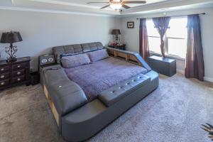 a bedroom with a large bed and a window at Hideaway Getaway in Statham