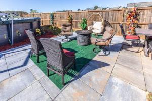 a patio with chairs and a table and a grill at Hideaway Getaway in Statham