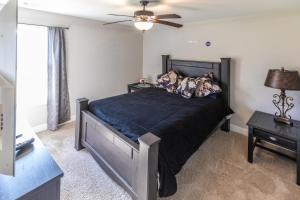 a bedroom with a bed and a ceiling fan at Hideaway Getaway in Statham +36 photos