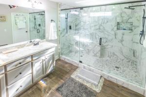 a bathroom with a shower and a sink at Hideaway Getaway in Statham