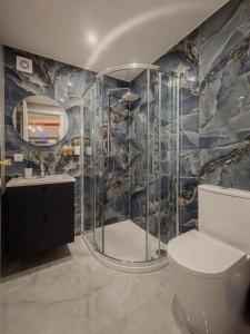 a bathroom with a shower and a toilet and a sink at Garden Apartments in Prague +61 photos