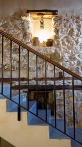 a staircase in a stone walled room with a stair railing at Casa Rural Las Camilas- Sierra de Alcaraz in Vianos