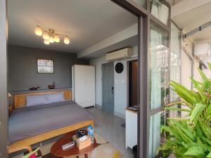 a bedroom with a bed and a window at T Home Balcony in Hanoi