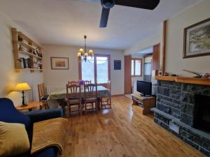 a living room with a table and a fireplace at VALDI-BIESCAS in Biescas